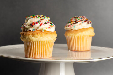 Classic butter cupcake with sprinkles and swirly icing on top