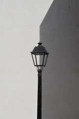 Fototapeta na wymiar street lamp on white background monochrome, play of light and shadow,