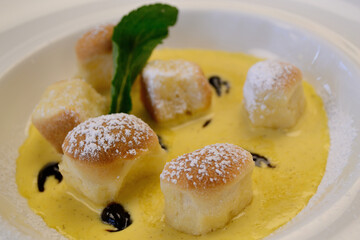 Delicious Dumplings On A Plate Garnished With Vanilla Sauce