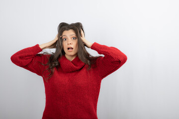 Surprised woman holding her head and looking up