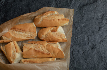 Freshly baked bread slices, on black background