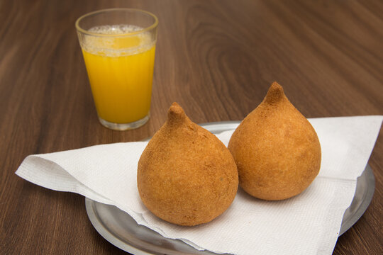 Coxinha e suco de laranja, t&iacute;pico lanche salgado feito com carne de frango muito comum em lanchonetes, festas e bares de todo o Brasil.