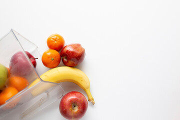 apples, pear, orange, banana pouring out of a blender jar