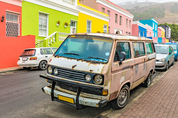 rusty bus infront of colorfull houses in captown south africa