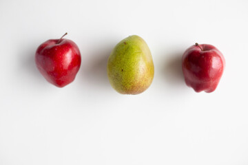 red apples and a green pear