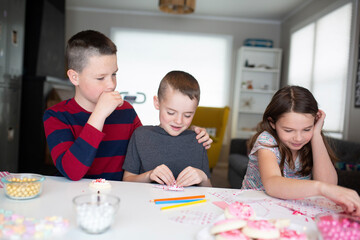 kids writing valentine's day cards