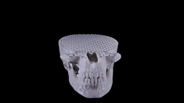 3D printed skull bone wire frame animation in camera effect against black background time lapse printer