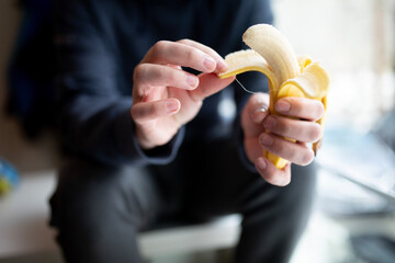 man peeling a banana