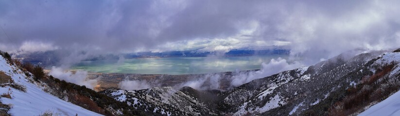 Lake Mountains Peak winter snow mountain hiking trail views via Israel Canyon towards Radio Towers, Utah Lake, Wasatch Front Rocky Mountains, Provo, Utah County. United States.