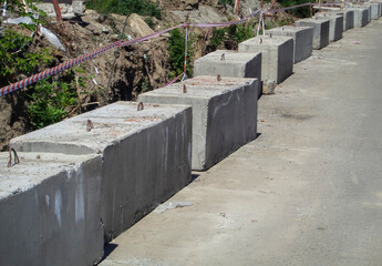 Construction of a concrete fence. Concrete blocks. Construction site
