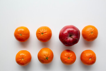small oranges and one apple