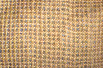 Jute hessian sackcloth canvas woven texture pattern background in light beige cream brown color blank empty