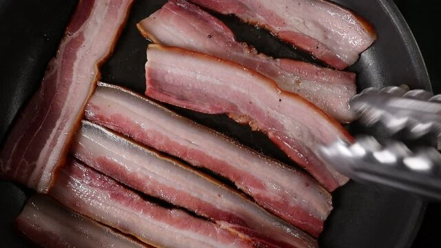 Italian pancetta frying in a pan