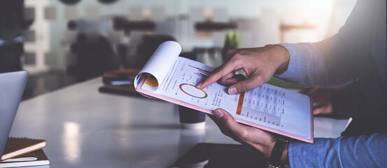 Businessman or Accountant checking data document on digital tablet for investigation of corruption account . Anti Bribery concept.