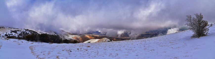 Lake Mountains Peak winter snow mountain hiking trail views via Israel Canyon towards Radio Towers, Utah Lake, Wasatch Front Rocky Mountains, Provo, Utah County. United States.