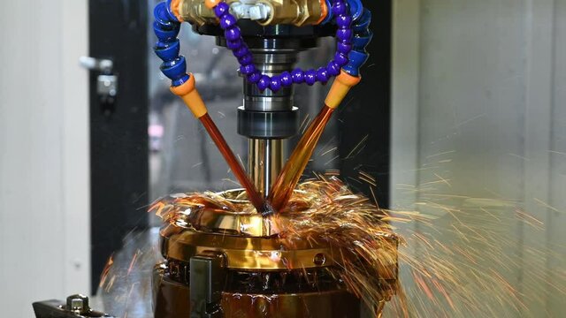 The CNC milling machine cutting the shell mold parts with oil coolant method. The mold and die manufacturing process by CNC machining center.