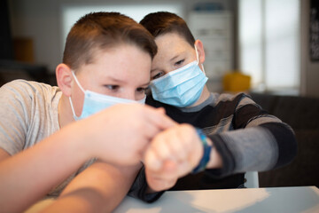 boys checking the time in masks