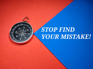 Selective focus.Compass and word STOP FIND YOUR MISTAKE! on a blue and red background.Business concept.Shot were noise and grain.
