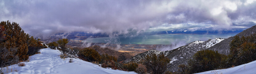 Lake Mountains Peak winter snow mountain hiking trail views via Israel Canyon towards Radio Towers, Utah Lake, Wasatch Front Rocky Mountains, Provo, Utah County. United States.
