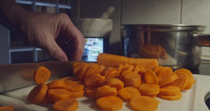 Chopping carrots for online cooking tutorial on mobile device