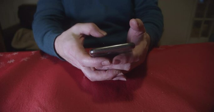 Hands using smartphone then impatiently resting on table, parallax