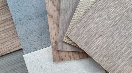 mood and tone interior material board presenting combination of wooden veneer samples and quartz stone tile samples. close up multi color and texture of veneer and artificial stone swatch.