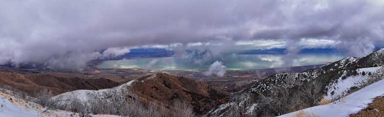 Lake Mountains Peak winter snow mountain hiking trail views via Israel Canyon towards Radio Towers, Utah Lake, Wasatch Front Rocky Mountains, Provo, Utah County. United States.