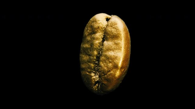 gold coffee bean rotating isolated on black background, macro shots