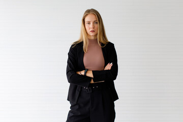 The image portrait. Happy beautiful caucasian woman in a businesswoman suit, black suit In the studio with a white background.