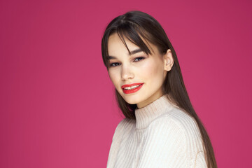 Fototapeta premium Woman with long hair and red lips white blouse pink background attractive look