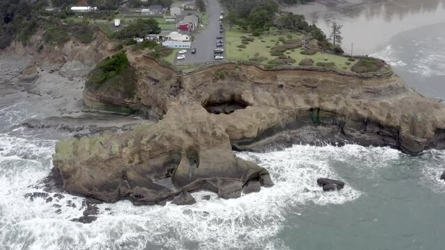 Devils Punch Bowl State Natural Area, Lincoln County in Oregon. Aerial circling