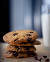 Stack of cookies with a glass of milk in the background