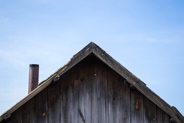 triangular roof of wooden house with planks