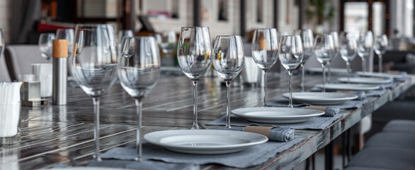 Fototapeta na wymiar Modern veranda restaurant interior, banquet setting, glasses, plates