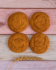 Oatmeal cookies with wheat on a wooden table. Rustic summer style. Cereals, rye and wheat.