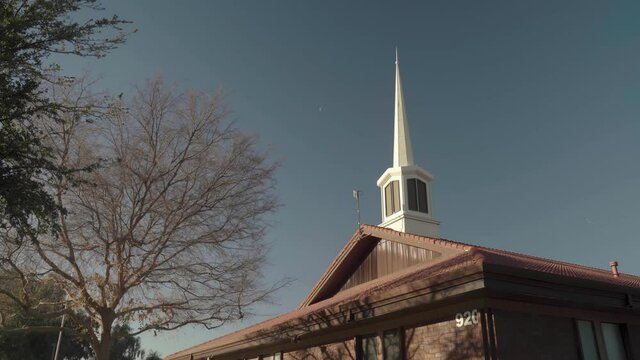 Mormon Church Spire with Moon and Plane Leaving Trail in the Sky 4K