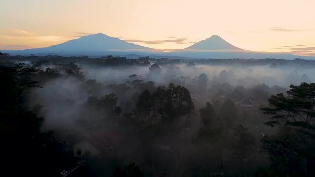 Scenic aerial view of Mount Merapi and Merbabu on misty morning Java, Indonesia