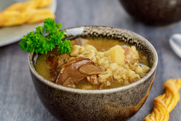Pearl barley soup with mushrooms and potato.