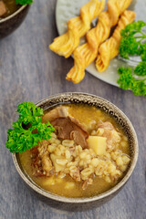 Healthy mushroom soup with pearl barley and potato.
