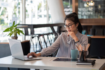Asian businesswoman work with laptop at the office.