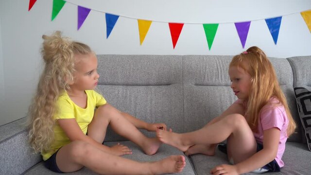 two little girls sharing secrets to each other while enjoying time together