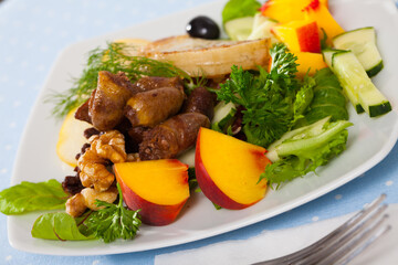 Salad with roasted chicken hearts, peach, pear and fried cheese
