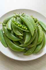 fresh sweet green peas on plate