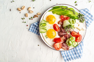 healthy keto breakfast egg, avocado, cheese, bacon and fresh salad. Healthy nutritious paleo keto breakfast concept. place for text, top view