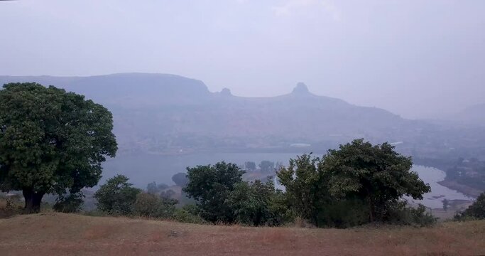 Flying Low Over Mountains Towards Scenic Lake At Trimbakeshwar Range During Foggy Day In Western Ghats Of India. - Revealing Shot 