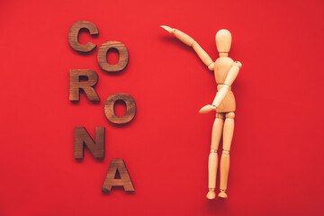 Wooden mannequin with word CORONA on color background