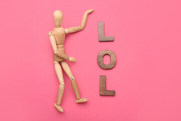 Wooden mannequin with word LOL on color background