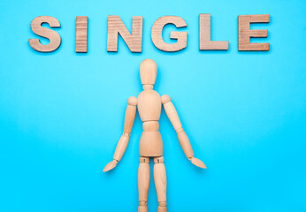 Wooden mannequin with word SINGLE on color background