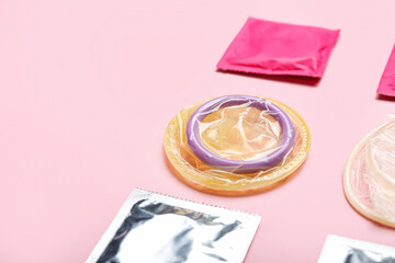 Wrapped and open condoms on color background - obrazy, fototapety, plakaty