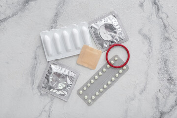 Different contraceptives on light background